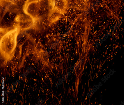 A black background with orange sparks and smoke