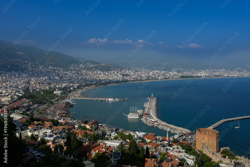 Fototapeta premium Panoramic Aerial View of Alanya City Harbor and Red Tower, Kizil Kule Landmark, Turkish Riviera Landscape with Mediterranean Sea, Antalya Coastline. Urban Travel Concept, Ancient Turkish Castle