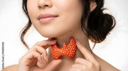 Young woman touching her neck near the thyroid gland, isolated against a white background indicating medical awareness for endocrine system health