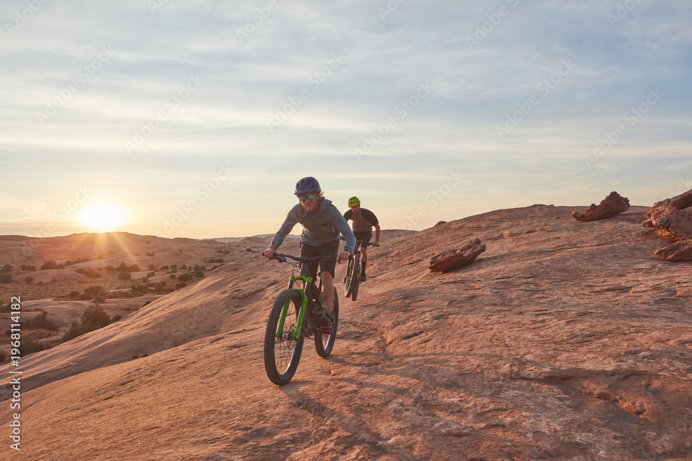 Fototapeta premium Mountain biking, adventure and fitness with men in nature for race, extreme sports and travel. Sky space, training and journey with people or friends on bicycle outdoor cycling, exercise and ride
