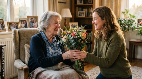 Woman giving flowers to senior lady.