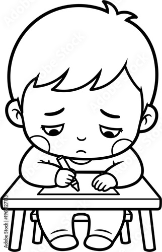 Little boy sitting at desk concentrating.