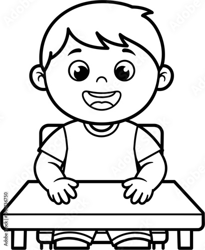 Happy little boy sitting at desk.