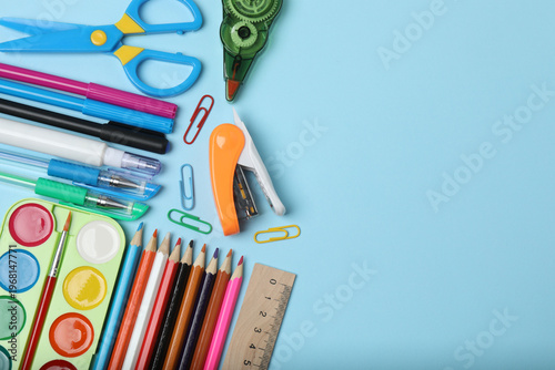School background. School supplies on the table, stationery, place for text on a blue background
