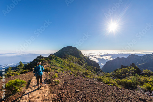 Tourist hiking on sunny day at Pico Ruivo in Madeira Portugal