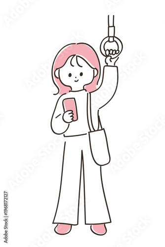 電車で吊り革を掴んでスマートフォンを見る若い女性