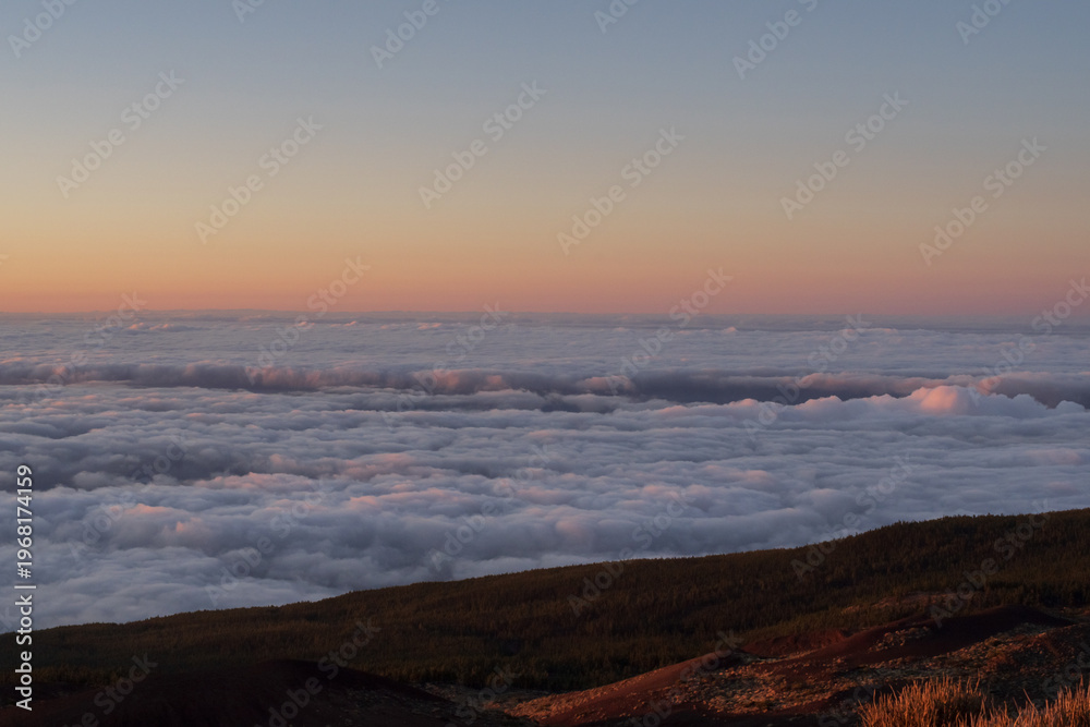 Fototapeta premium Sunset above clouds in Teide National Park Tenerife, volcanic mountains and sea of clouds landscape