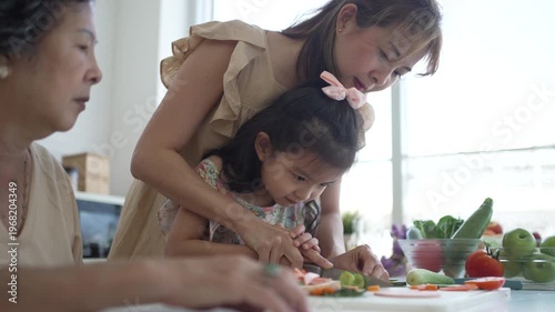 Daughter, mother and grandmother are preparing food together in the kitchen. Relationship, family, domestic life.