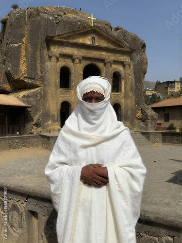 Pilgrim at rock-hewn Church of Saint George in Lalibela
