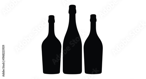Three champagne bottles stand together in a dark silhouette