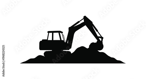 Black excavator digging into a pile of earth dramatic silhouette