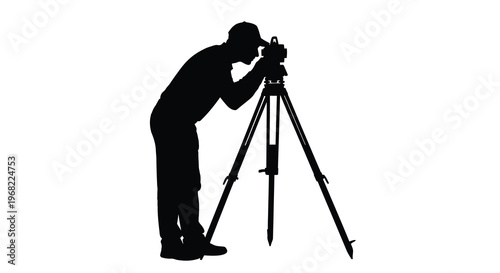 Surveyor using a theodolite and tripod a striking black silhouette