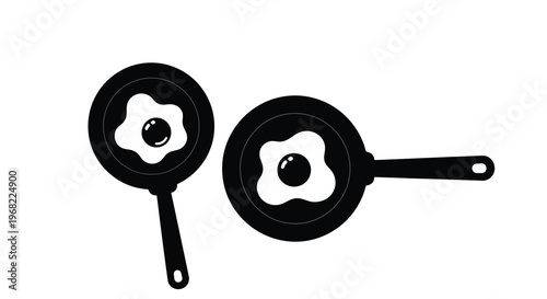 Two frying pans with fried eggs depicted as a black silhouette