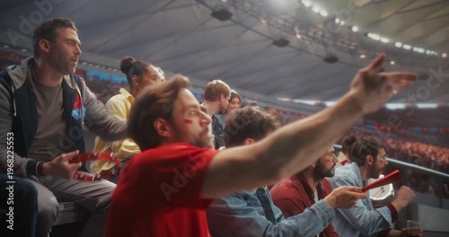 Diverse Stadium Fans Cheer Passionately for Their Soccer Team, Waving Scarves, Clapping, Pointing and Celebrating Together From the Stands During an Exciting Live Match on Euro Cup Arena