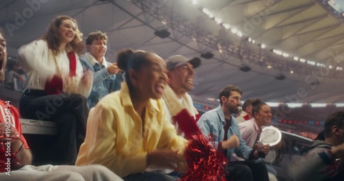 Diverse Fans in a Stadium Cheer as a Soccer Team Scores in a Championship Event, Celebrating a Goal With Applause and Raised Arms in a Professional Sport Arena During an International Match.