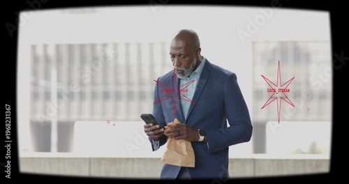 mature man checking phone and eating sandwich during business lunch, red overlay animating near him