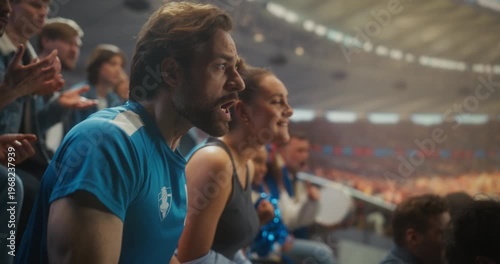 Devastated Sports Fans in Blue React to a Painful Loss in a Huge Open Stadium as Man Grabs His Head in Disbelief and Nearby Supporters Slump, Frustration, and Anger. Losing Match and Game