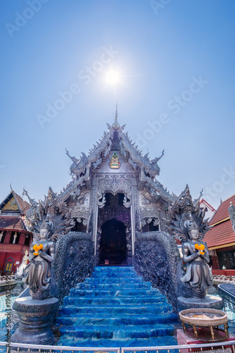 The stunning Silver Shrines or Wat Sri Suphan, a famous silver chapel decorated with traditional Lanna intricate carvings under a bright sunny sky in Chiang Mai, Thailand.
