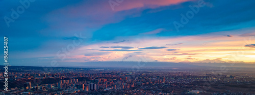 Panoramic cityscape at twilight with dramatic sky colors