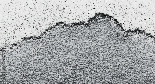 Close-up view of a textured, rough, and uneven surface with dark edges and a grainy appearance.