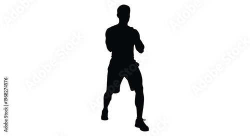 Man standing confidently with arms akimbo in a stark silhouette