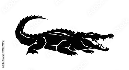 Black silhouette of a powerful crocodile with open jaws.