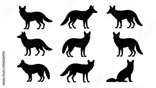 Collection of black silhouettes of wolves in various dynamic poses Vector