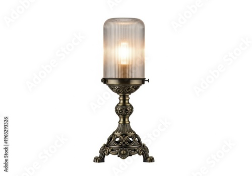 Vintage style table lamp with a ribbed glass shade and an ornate bronze base isolated on white background