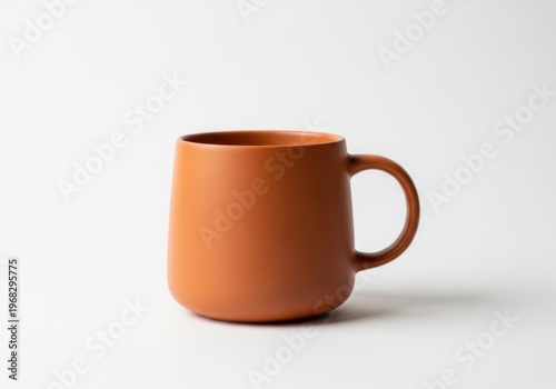 A simple orange ceramic mug isolated on white background