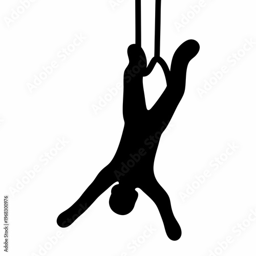 Gymnast in silhouette performing an inverted pose on gymnastic rings