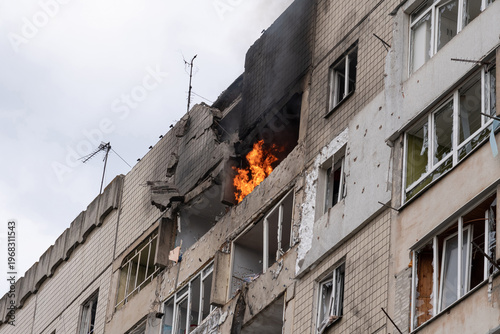 Fire in the apartment. Partially destroyed wall of the house. Broken windows in the windows. Consequences of a drone hitting a residential building