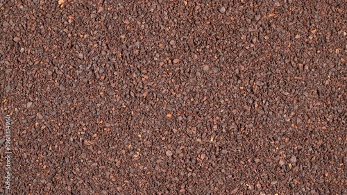 Top-down rotating background of rich ground coffee powder. Premium roasted dark brown texture for cinematic cafe and barista video projects.