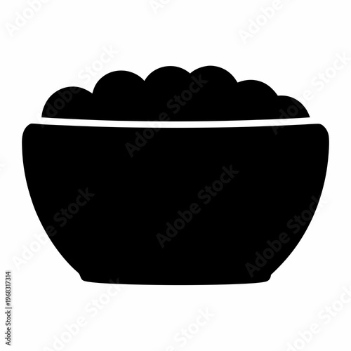 A simple black bowl filled with some sort of food on top