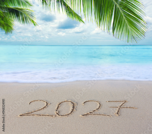 New Year 2027 background with hand written in the white Caribbean sea beach.