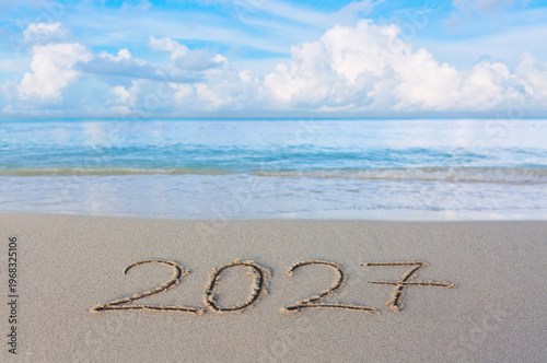 New Year 2027 background with hand written in the white Caribbean sea beach.