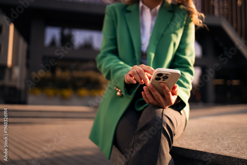 Obraz na plátně Businesswoman using smartphone outdoors connecting with technology