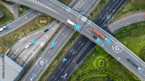 Valokuva Aerial view of modern highway interchange with autonomous vehicles and connectivity symbols