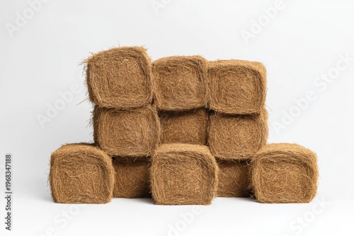 Rustic hay bales stacked in a farm setting with a minimalistic approach