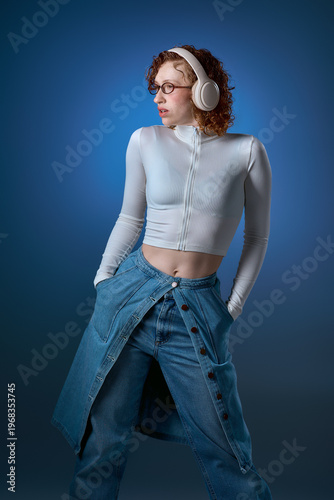 Young woman with red curly hair enjoys music in a modern studio setting