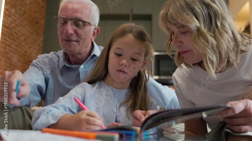 Grandparents and grandchild coloring together creating family memories