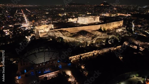 Aerial drone cinematic night video of iconic Acropolis hill and the Parthenon, Athens historic centre, Attica, Greece