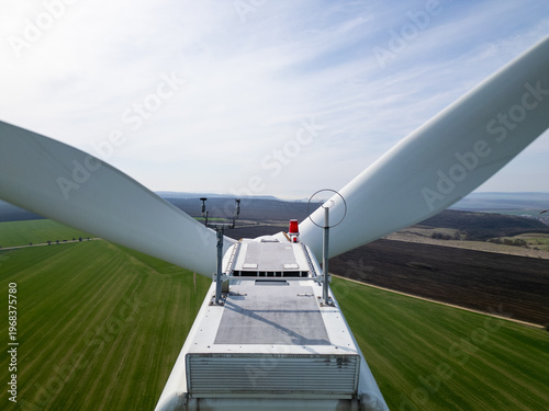 Aerial Close-up of Wind Turbine Nacelle and Blades Over Green Fields