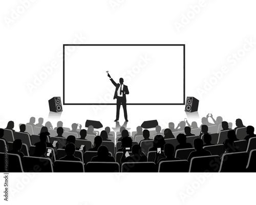 A professional businessman gives a dynamic presentation, addressing a large audience gathered for a conference.