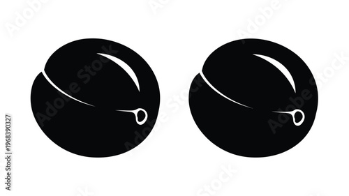 Two black plums displayed side by side in a striking silhouette