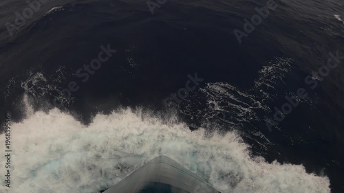 Top view of the bow of an ocean liner cutting through ocean waters