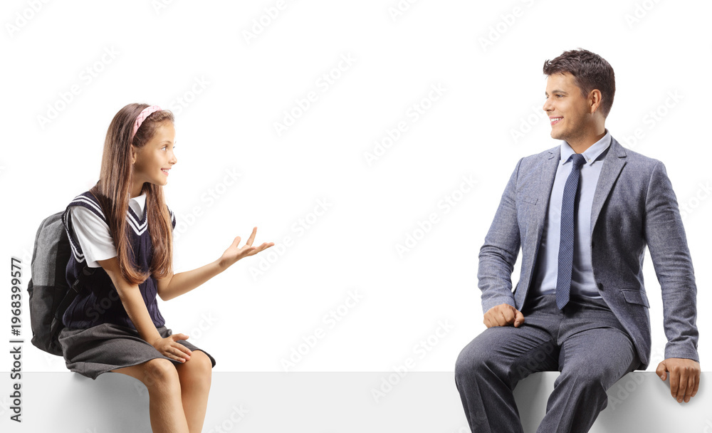 Obraz premium Schoolgirl and a man sitting on a blank panel and having a conversation