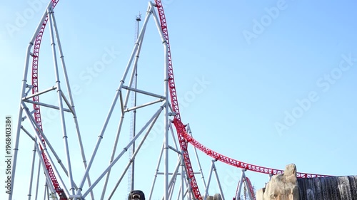 roller coasters at an amusement park against a blue sky