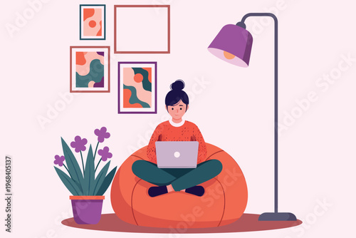 Woman working on laptop sitting on a beanbag chair with home decor