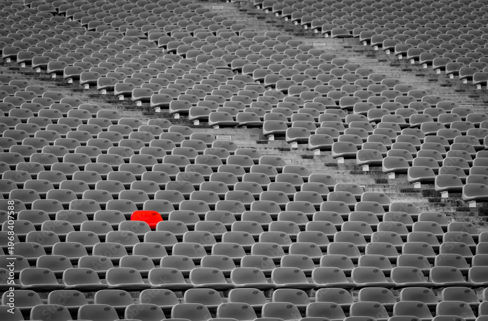 Fototapeta premium Outstanding empty red plastic seats in football stadium with rows of unoccupied chairs at outdoor soccer arena, reserved seating concept during match preparation. Sport venue infrastructure.