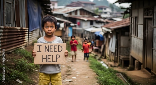 A Young Child Holds a Cardboard Sign That Says 